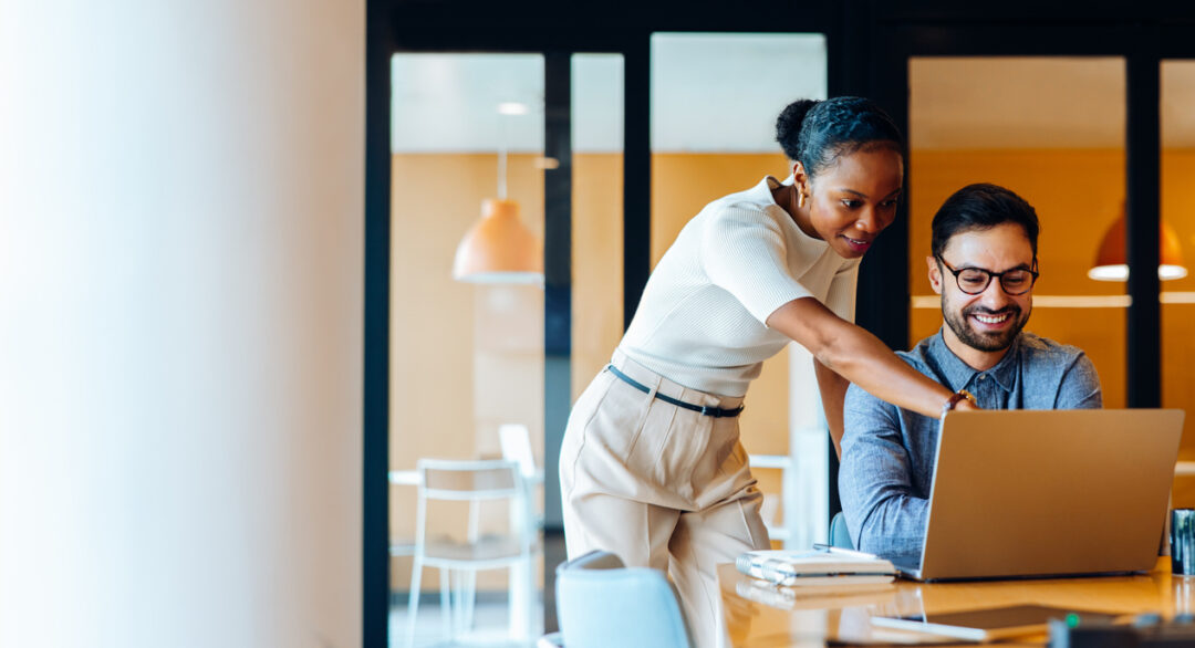 Insurance broker working at a desk reviewing case submissions, illustrating how Word & Brown's back-office support and carrier escalation services save independent agents time