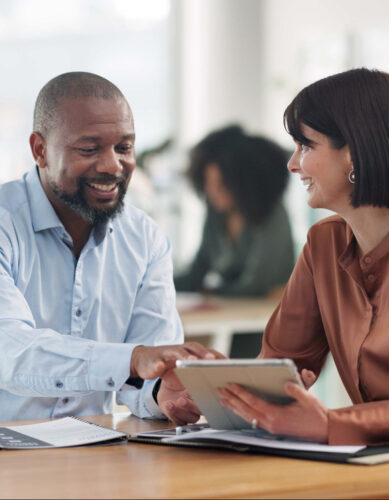 Insurance broker asking a small business client questions to build trust during a benefits meeting
